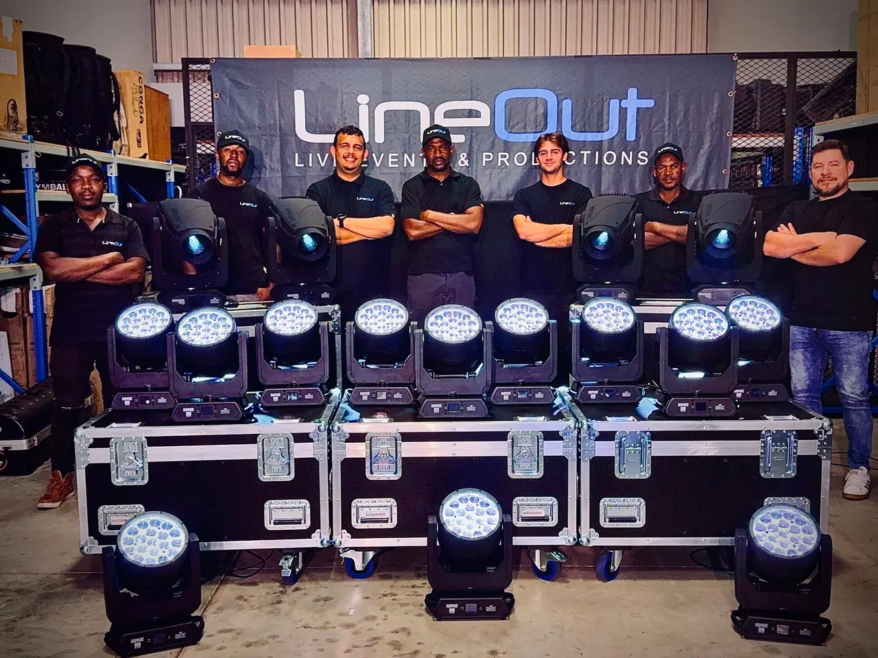 The LineOut crew with a row of new Chauvet moving heads in front of a LineOut banner
