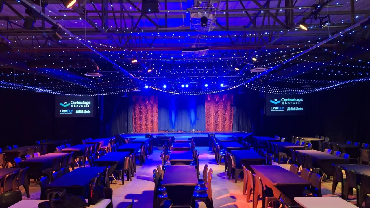 Centrestage@Baywest set for a show, with the installed lighting rig, stage and side screens
